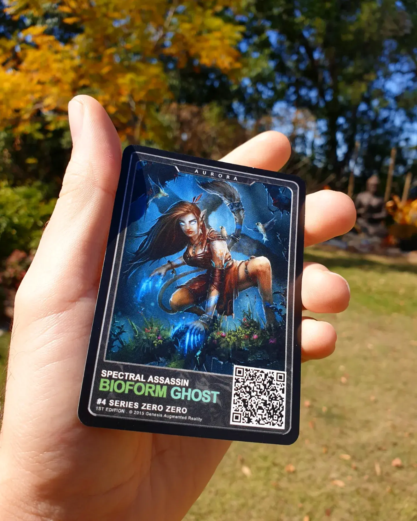 The Aurora trading card from the Genesis AR TCG (Augmented Reality Trading Card Game) held in a mans hand